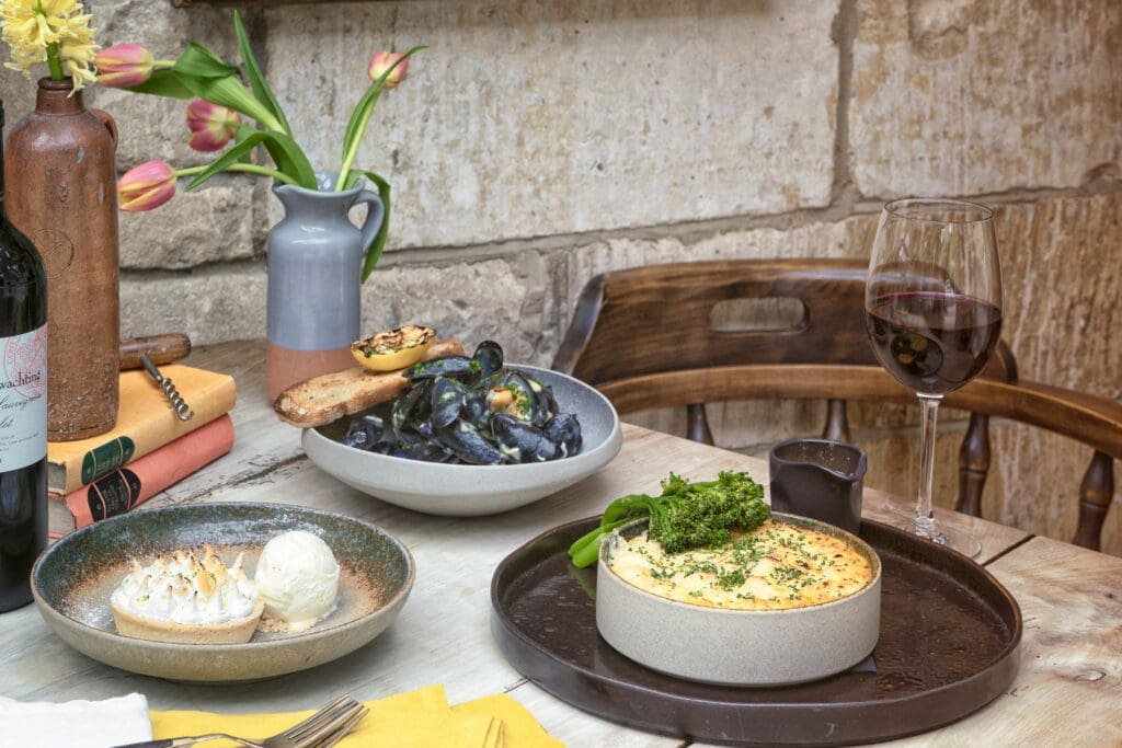 Group shot of Fisherman's pie, mussels, key lime pie and a glass or merlot.